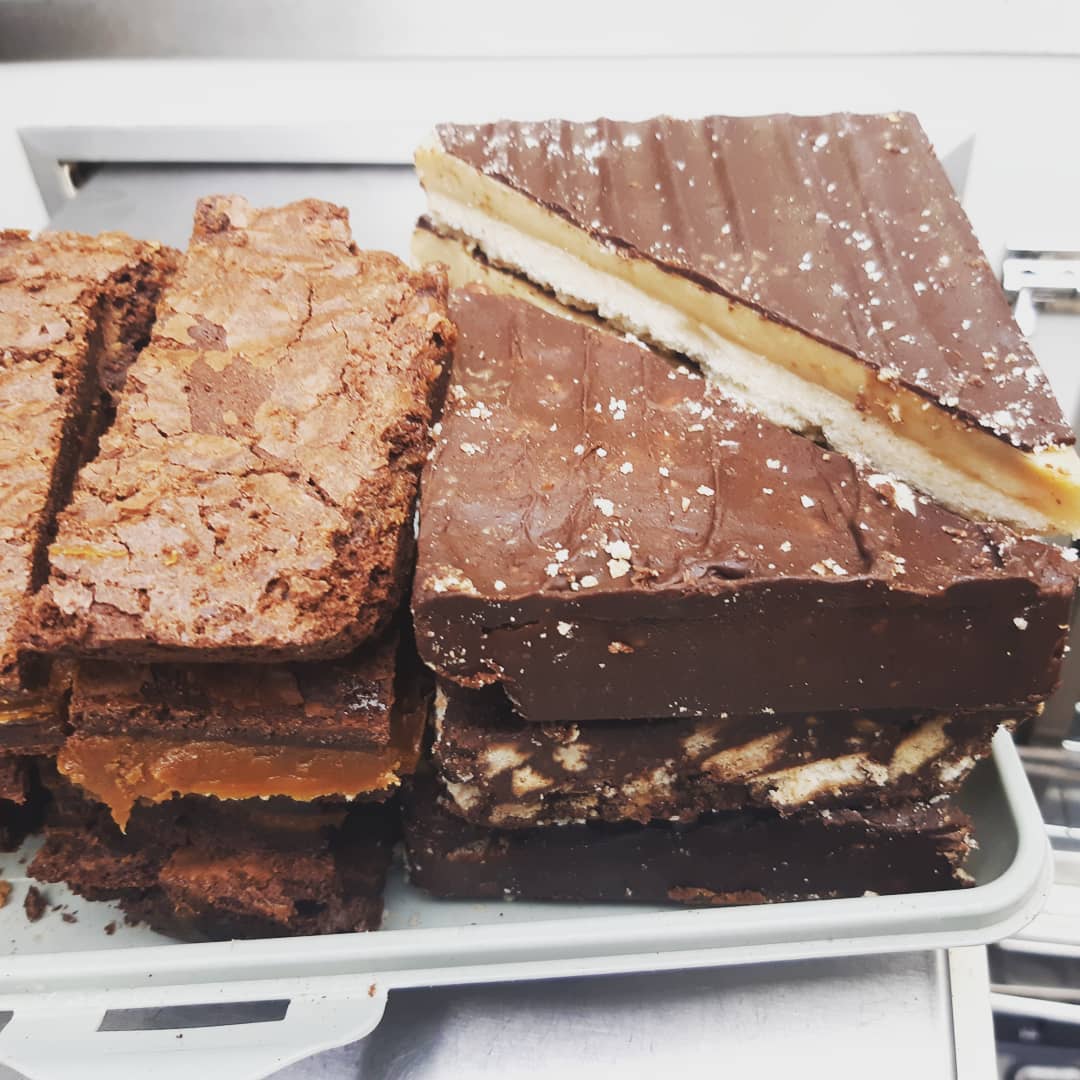 Millionaire shortbread and brownies stacked on van tray